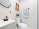 Compact bathroom features modern fixtures, a vanity with sink, and a toilet with coordinated accessories at 843 W Swoope Ave, Winter Park, FL 32789