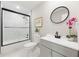 Tasteful bathroom with framed mirror, tub/shower with glass doors and vanity at 843 W Swoope Ave, Winter Park, FL 32789