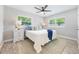 Bright bedroom with two windows, ceiling fan, and stylish decor for a modern and comfortable living space at 843 W Swoope Ave, Winter Park, FL 32789
