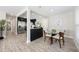 Bright dining area features a glass table, wood chairs, and an open floor plan to the kitchen at 843 W Swoope Ave, Winter Park, FL 32789