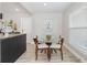 Cozy dining area with modern glass table seating four, adjacent to a kitchen bar at 843 W Swoope Ave, Winter Park, FL 32789