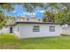 Rear exterior of a white-painted home featuring black trim and a well-maintained lawn at 843 W Swoope Ave, Winter Park, FL 32789