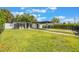 Charming home exterior showcasing a covered parking area, lush lawn, and tasteful landscaping at 843 W Swoope Ave, Winter Park, FL 32789