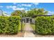 Charming home with black wrought iron fence, landscaped walkway, and mature hedges at 843 W Swoope Ave, Winter Park, FL 32789