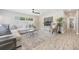 Bright living room featuring a comfortable sectional sofa, stylish decor, and wood-look floors at 843 W Swoope Ave, Winter Park, FL 32789
