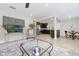 Bright living room with open layout to kitchen, featuring neutral tones and modern decor at 843 W Swoope Ave, Winter Park, FL 32789