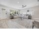Bright living room featuring a comfortable sectional sofa, stylish decor, and wood-look floors at 843 W Swoope Ave, Winter Park, FL 32789
