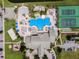 An aerial view showcases the community pool, tennis courts, pickle ball, and ample parking at 8971 California Palm Rd, Kissimmee, FL 34747