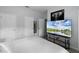 Bright bedroom boasts modern entertainment and ample storage space via three doors at 8971 California Palm Rd, Kissimmee, FL 34747