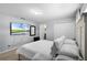 Bright bedroom featuring a comfortable bed, mounted television and adjacent bathroom at 8971 California Palm Rd, Kissimmee, FL 34747