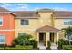 Beautiful two story exterior of townhome featuring tiled roof and lush landscaping at 8971 California Palm Rd, Kissimmee, FL 34747