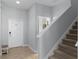 Light-filled foyer with tile flooring, stairs, and white front door at 8971 California Palm Rd, Kissimmee, FL 34747