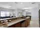 Kitchen featuring granite counters, stainless steel dishwasher, and an adjacent dining area at 8971 California Palm Rd, Kissimmee, FL 34747