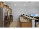 Kitchen featuring stainless steel appliances, granite countertops, tile backsplash and breakfast bar at 8971 California Palm Rd, Kissimmee, FL 34747
