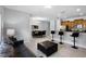 A spacious living room features tile floors, a leather sofa and opens to a dining area and kitchen at 8971 California Palm Rd, Kissimmee, FL 34747