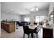 Open concept living room features granite countertops, stainless appliances and dining area at 8971 California Palm Rd, Kissimmee, FL 34747