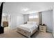 Inviting bedroom features an ensuite bathroom, large window, and neutral decor at 8971 California Palm Rd, Kissimmee, FL 34747