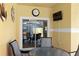 Covered outdoor patio with a glass table, chairs, and view of pool at 8971 California Palm Rd, Kissimmee, FL 34747