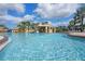 Refreshing pool featuring waterfalls, fountains and clear blue water under a sunny sky at 8971 California Palm Rd, Kissimmee, FL 34747