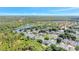 Beautiful aerial view of a residential community with tree-lined streets, lakes, and lush greenery at 9999 Shadow Creek Dr, Orlando, FL 32832