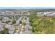 A peaceful neighborhood is captured from above, highlighting tree-lined streets and serene ponds at 9999 Shadow Creek Dr, Orlando, FL 32832