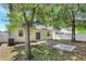 The backyard features mature trees, a back patio and bright fencing at 9999 Shadow Creek Dr, Orlando, FL 32832