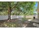 The backyard features mature trees and a large, bright fence at 9999 Shadow Creek Dr, Orlando, FL 32832