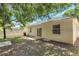 The backyard features mature trees, a back patio and bright fencing at 9999 Shadow Creek Dr, Orlando, FL 32832