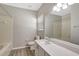 This bathroom has a large mirror, tub and shower combination and long vanity at 9999 Shadow Creek Dr, Orlando, FL 32832