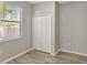 Bedroom featuring a window and a double door closet and wood-look flooring at 9999 Shadow Creek Dr, Orlando, FL 32832