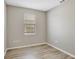 Bedroom featuring wood-look flooring and a large window at 9999 Shadow Creek Dr, Orlando, FL 32832