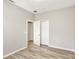 This bedroom has wood-look floors, two closets and neutral paint at 9999 Shadow Creek Dr, Orlando, FL 32832