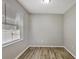 This bedroom has wood-look floors, a window with blinds and neutral paint at 9999 Shadow Creek Dr, Orlando, FL 32832