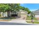 A two-story home is landscaped with healthy green foliage and mature trees at 9999 Shadow Creek Dr, Orlando, FL 32832