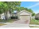 A two-story home is landscaped with healthy green foliage and mature trees at 9999 Shadow Creek Dr, Orlando, FL 32832