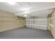 Spacious garage featuring a garage door and wall shelving at 9999 Shadow Creek Dr, Orlando, FL 32832
