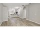 Spacious living room with light gray walls, modern hard-surface flooring and arched doorways at 9999 Shadow Creek Dr, Orlando, FL 32832