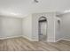 Inviting living room with new flooring, neutral paint, arched doorways, and lots of natural light at 9999 Shadow Creek Dr, Orlando, FL 32832
