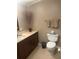 Well-maintained bathroom with ample cabinet space, a clean toilet, and a stylish vase at 117 Darlene Ct, Davenport, FL 33897