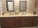 Bathroom featuring a double vanity with stylish faucets, undermount sinks, and storage cabinets at 117 Darlene Ct, Davenport, FL 33897