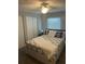 Cozy bedroom with neutral tones, features a spacious closet and soft natural lighting at 117 Darlene Ct, Davenport, FL 33897