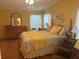 Bright bedroom with a decorative bed, ceiling fan, and a classic dresser at 117 Darlene Ct, Davenport, FL 33897