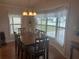 Dining room featuring a large table, six chairs, and a large bay window at 117 Darlene Ct, Davenport, FL 33897
