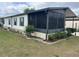 A view of the home's exterior, showing a screened-in porch and tidy landscaping at 117 Darlene Ct, Davenport, FL 33897