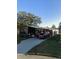 Cozy single-story home with a carport, screen porch, and well-maintained landscaping at 117 Darlene Ct, Davenport, FL 33897