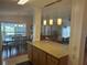 Open-concept kitchen featuring pendant lighting, granite countertops, and views of the dining and living area at 117 Darlene Ct, Davenport, FL 33897