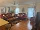 Cozy living room featuring wood floors, ceiling fan, and comfortable seating at 117 Darlene Ct, Davenport, FL 33897