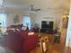 Spacious living room with a large flat-screen TV, comfortable seating, ceiling fan, and modern decor at 117 Darlene Ct, Davenport, FL 33897