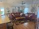 Inviting living room features a ceiling fan, stylish decor and plenty of comfortable seating and natural light at 117 Darlene Ct, Davenport, FL 33897