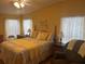 Comfortable main bedroom featuring hardwood floors, bright walls, and ample natural light at 117 Darlene Ct, Davenport, FL 33897